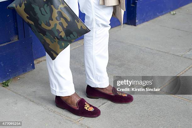 Editorial Director of GCaribbean magazine Geoff K Cooper wears Bonbos trousers, Stubbs and wootton shoes, Fendi bag on day 2 of London Collections:...