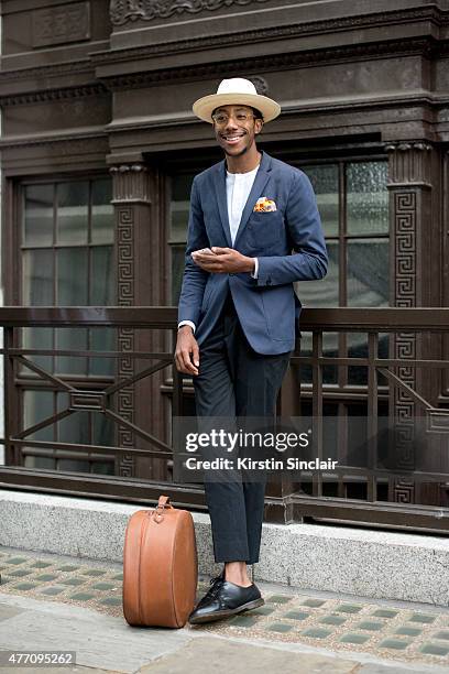 Milliner and fashion blogger La Touche wears Spencer Hart jacket, trousers and top, Dr. Martens shoes, Lianne La Touche pocket square and Locke and...