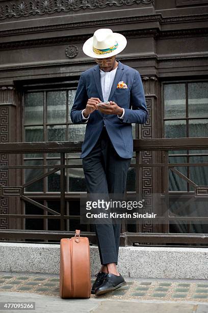 Milliner and fashion blogger La Touche wears Spencer Hart jacket, trousers and top, Dr. Martens shoes, Lianne La Touche pocket square and Locke and...