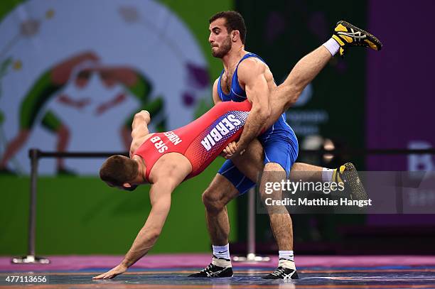 Elvin Mursaliyev of Azerbaijan and Viktor Nemes of Serbia compete in the Men's Wrestling 75kg Greco Roman final during day two of the Baku 2015...