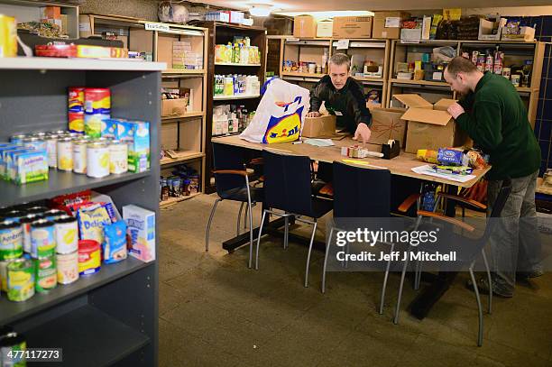 Stuart Little volunteer packs food at a food bank on March 7, 2014 in Whitburn, Scotland. Charities based in Scotland are reporting that many...