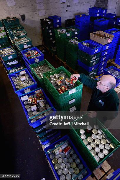 Alf Collington volunteer packs food at a food bank on March 7, 2014 in Falkirk, Scotland. Charities based in Scotland are reporting that many...