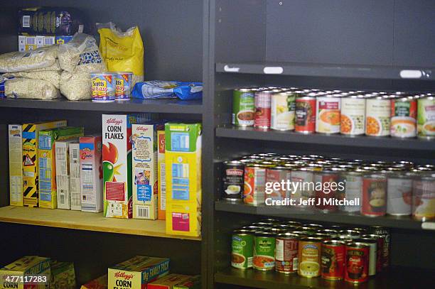 Cans of food are stacked on the shelves at a food bank on March 7, 2014 in Whitburn, Scotland. Charities based in Scotland are reporting that many...