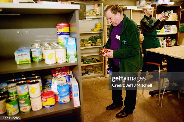 Stuart Little volunteer packs food at a food bank on March 7, 2014 in Whitburn, Scotland. Charities based in Scotland are reporting that many...