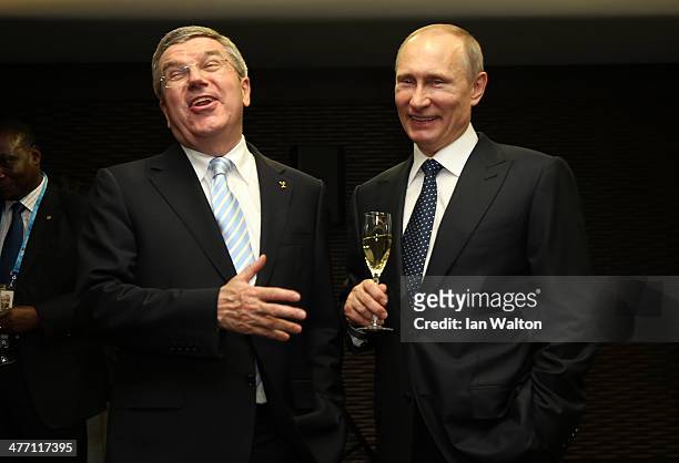Thomas Bach the President of the International Olympic Committee and Vladimir Putin the President of Russia share a joke the Opening Ceremony of the...