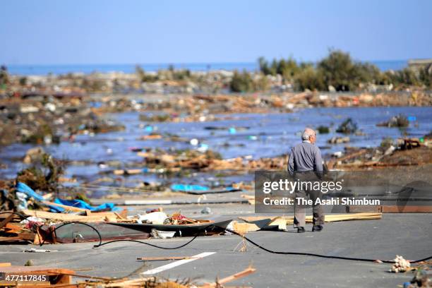 Man strands the tsunami devastated area to search his relative a day after the magnitude 9.0 strong earthquake and subsequent tsunami struck on March...