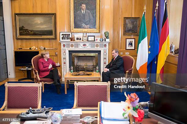 In this photo provided by the German Government Press Office , German Chancellor Angela Merkel speaks with Irish Prime Minister Enda Kenny during the...