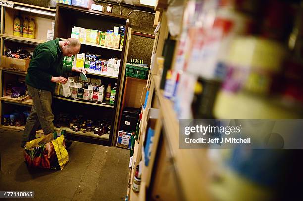 Stuart Little volunteer packs food at a food bank on March 7, 2014 in Whitburn, Scotland. Charities based in Scotland are reporting that many...