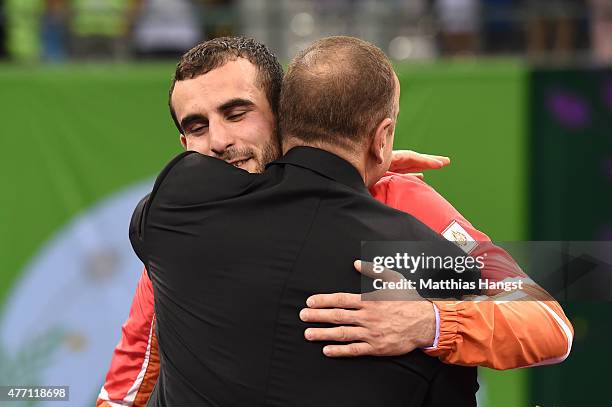 Gold Medalist Elvin Mursaliyev of Azerbaijan embraces the President of Azerbaijan Ilham Aliyev prior to receiving his medal won in the Men's...