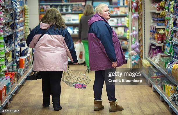 Customers browse goods inside a Poundland discount store, operated by Poundland Group Plc in London, U.K., on Friday, March 7, 2014. Poundland Group...