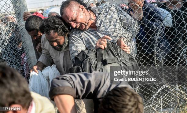 Syrians fleeing the war pass through border fences to enter Turkish territory illegally, near the Turkish border crossing at Akcakale in Sanliurfa...