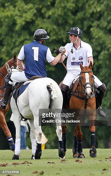 Prince Harry and Prince William, Duke of Cambridge shake hands at the end of the Gigaset Charity Polo Match at Beaufort Polo Club on June 14, 2015 in...
