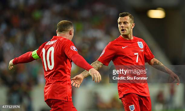 Jack Wilshere of England celebrates scoring their first goal with Wayne Rooney of England during the UEFA EURO 2016 Qualifier between Slovenia and...