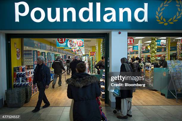 Customers enter and exit a Poundland discount store, operated by Poundland Group Plc in London, U.K., on Friday, March 7, 2014. Poundland Group Plc...