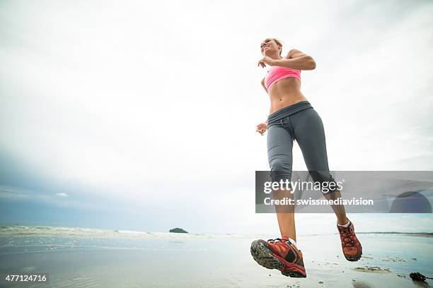 young woman training on the beach - low angle view shoe stock pictures, royalty-free photos & images