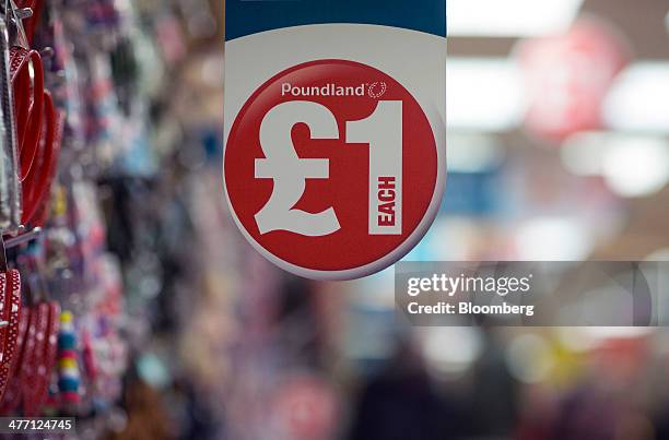 Logo advertising the cost of goods sits on a display shelf inside a Poundland discount store, operated by Poundland Group Plc in London, U.K., on...