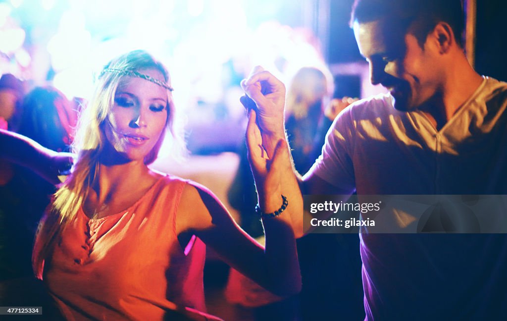 Two people dancing at concert.