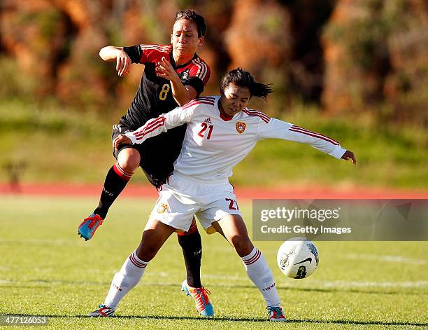 Nadine Kessler of Germany challenges Wang Lisi of China during the Algarve Cup 2014 match between Germany and China on March 07, 2014 in Albufeira,...