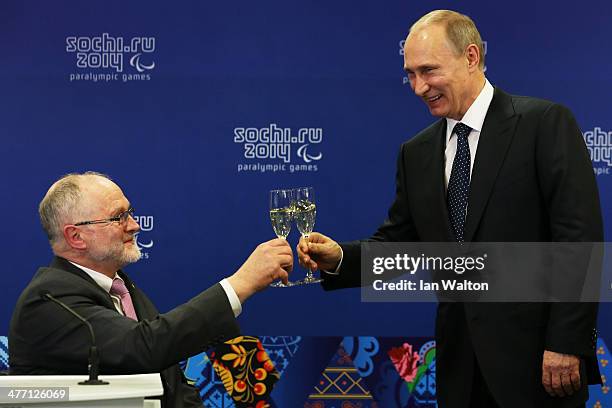 Sir Philip Craven the President of the International Paralympic Committee and Vladimir Putin the President of Russia perform a 'toast' prior to the...
