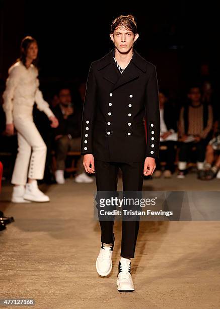 Model walks the runway at the Alexander McQueen show during The London Collections Men SS16 at The Arches on June 14, 2015 in London, England.