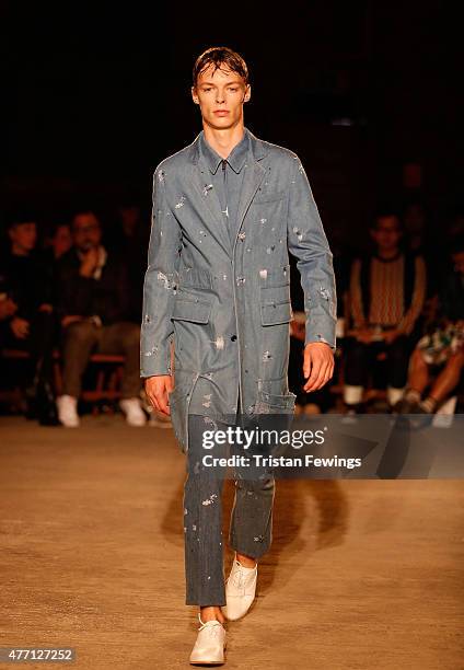 Model walks the runway at the Alexander McQueen show during The London Collections Men SS16 at The Arches on June 14, 2015 in London, England.