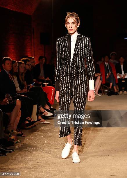 Model walks the runway at the Alexander McQueen show during The London Collections Men SS16 at The Arches on June 14, 2015 in London, England.