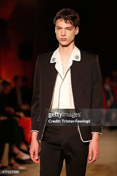 Model walks the runway at the Alexander McQueen show during The London Collections Men SS16 at The Arches on June 14, 2015 in London, England.