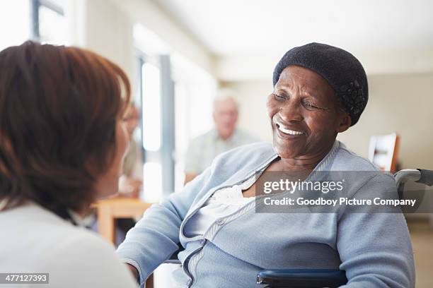 sharing a smile with her caregiver - nurse smiling stock pictures, royalty-free photos & images