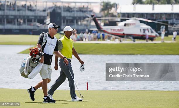 Tiger Woods walks with his caddie Joe LaCava on the tenth hole during the second round of the World Golf Championships-Cadillac Championship at Trump...