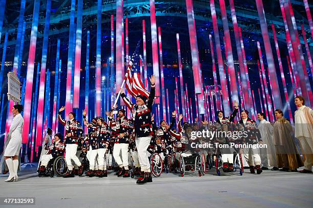 Jonathan Lujan of United States carries the flag during the Opening Ceremony of the Sochi 2014 Paralympic Winter Games at Fisht Olympic Stadium on...