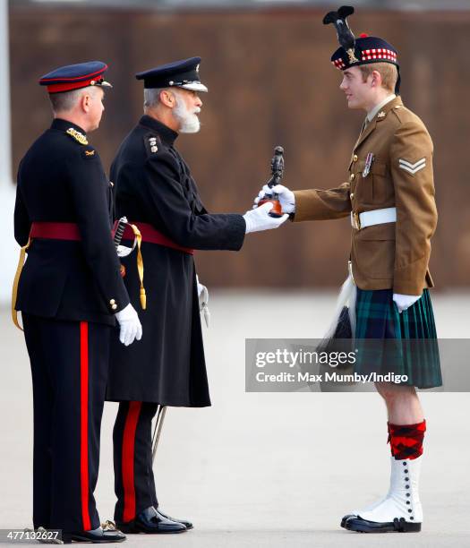 Prince Michael of Kent presents prizes to award winning soldiers as he attends the 76 Battery, Royal Artillery Pass Off Parade at Alexander Barracks...