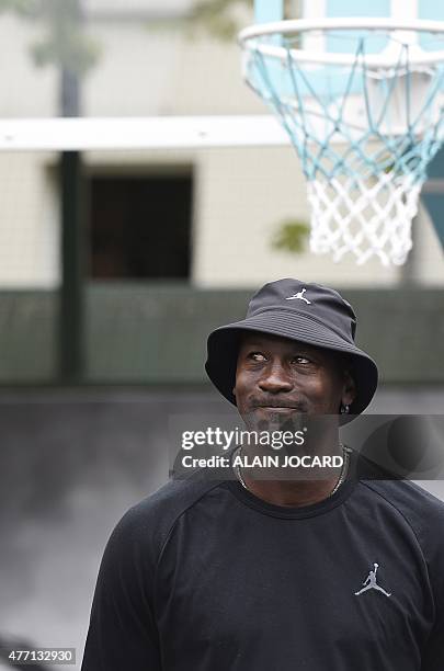 Former basketball player Michael Jordan looks on as he attends the inauguration of a street basketball court in the Haies sports ground in Paris on...