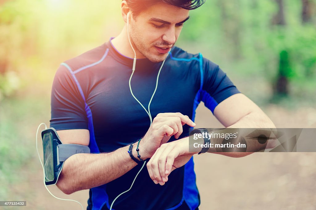 Runner in the park using smart watch