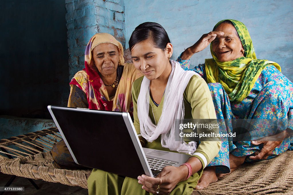Mother and Daughter Holding Laptop at Home