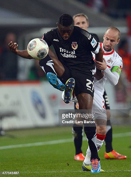 Boubacar Sanogo of Cottbus is challenged by Miso Brecko of Koeln during the Second Bundesliga match between 1. FC Koeln and Energie Cottbus at...