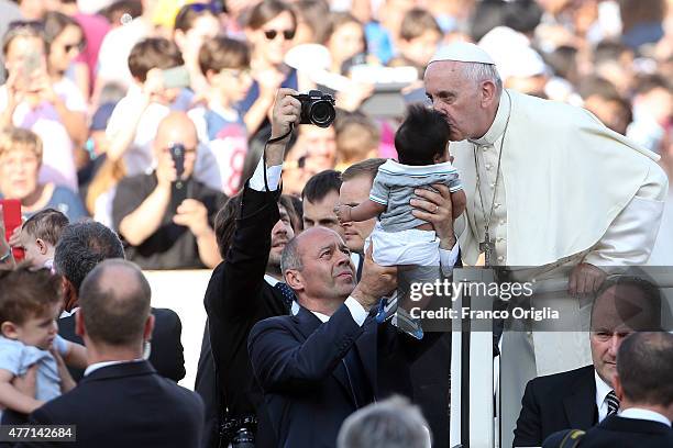Pope Francis greets a baby as he arrives in St. Peter's Square for a meeting with the Roman Diocesans on June 14, 2015 in Vatican City, Vatican. The...
