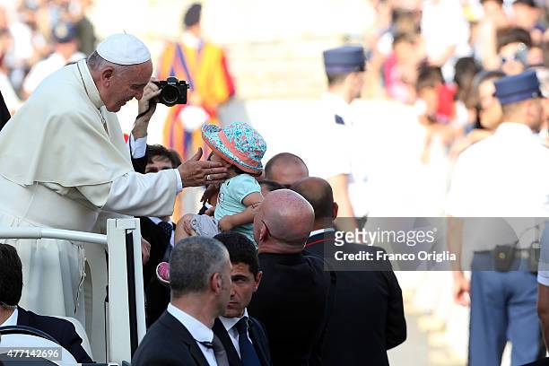 Pope Francis greets a baby as he arrives in St. Peter's Square for a meeting with the Roman Diocesans on June 14, 2015 in Vatican City, Vatican. The...