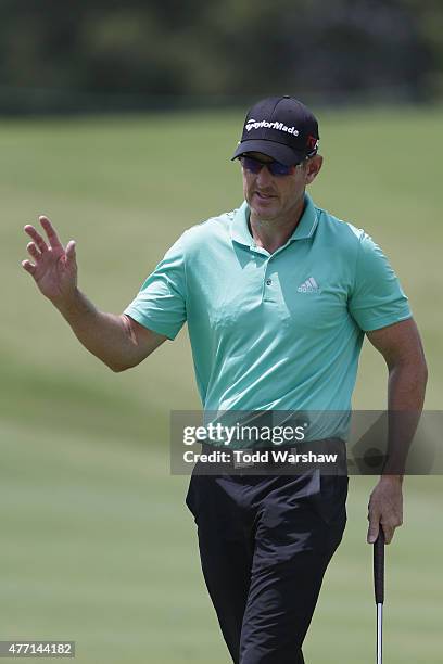 Greg Owen of England acknowledges the crowd on the 8th hole during the final round of the FedEx St. Jude Classic at TPC Southwind on June 14, 2015 in...