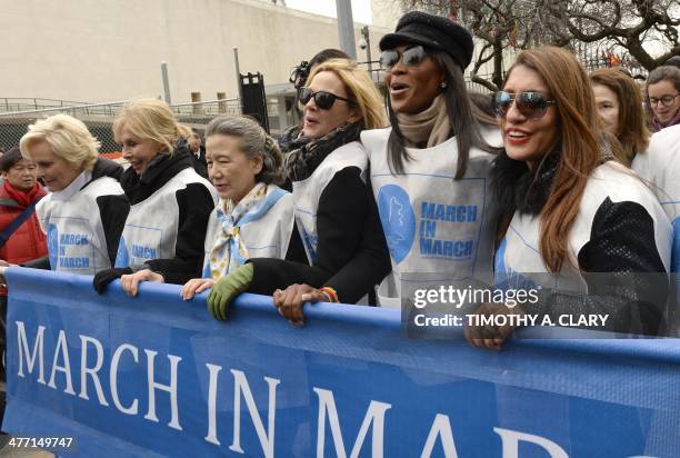 Cindy McCain, Trudy Styler, Ban Soon Taek, Kim Cattrall, Naomi Campbell and Uma Pemmaraju march from the United Nations March 7, 2014 during the UN...