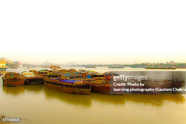 small barges parked at river ganges-calcutta,india - howrah bridge stock pictures, royalty-free photos & images