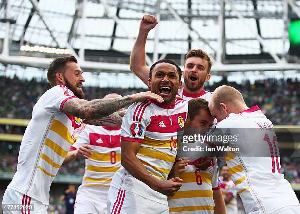 Shaun Maloney of Scotland is mobbed by team mates including Ikechi Anya and Steven Naismith after scoring his goal during the UEFA EURO 2016...