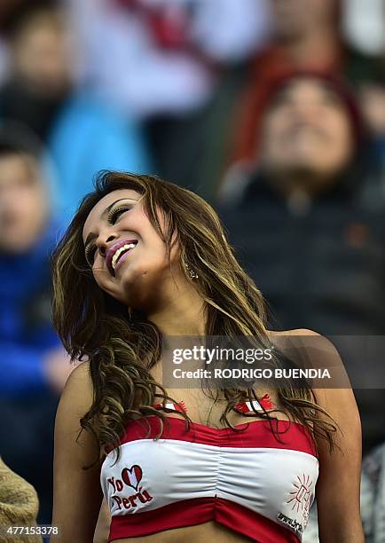 Supporter of Peru cheers for her team before the Copa America 2015 football match against Brazil on June 14, 2015 in Temuco, Chile. AFP PHOTO /...