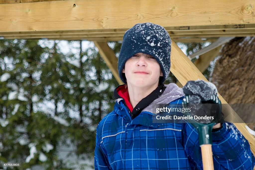 Boy with shovel in the snow