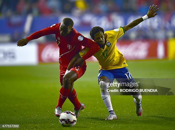 Peru's defender Luis Advincula and Brazil's midfielder Fred vie during their 2015 Copa America football championship match, in Temuco, Chile, on June...