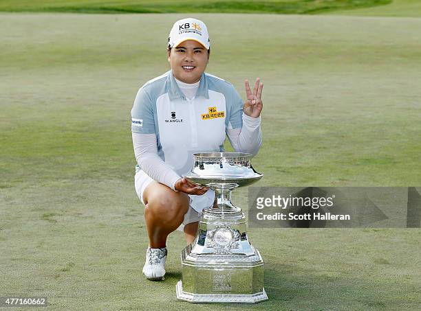 Inbee Park of South Korea poses with the trophy after her five-stroke victory at the KPMG Women's PGA Championship on the West Course at the...
