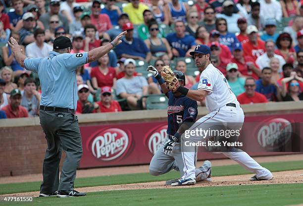 Bob Davidson umpire calls Eduardo Escobar of the Minnesota Twins safe against Joey Gallo of the Texas Rangers after Escobar hits a triple the sixth...