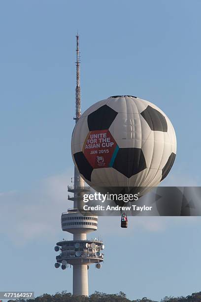 The Asian Cup hot air balloon flys past Canberra's Telstra tower during a joy flight with the Australian Capital territory's Sport and Tourism...