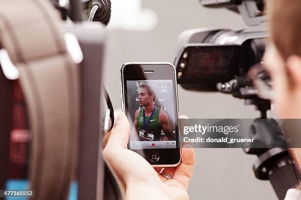 reporter using smartphone to record nick symmonds post-win press conference - press conference cameras stock pictures, royalty-free photos & images