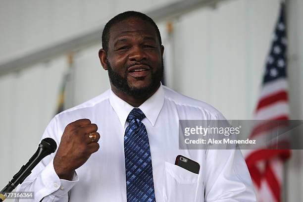 Champion boxer Riddick Bowe holds up his hall of fame ring as he speaks during the induction ceremony at the International Boxing Hall of Fame...