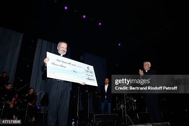 Monseigneur Pascal Gollnish Directeur des Oeuvres d orient receives a Check for 'les Chretiens d'Orient' by Monseigneur Jean-Michel di Falco Leandri...